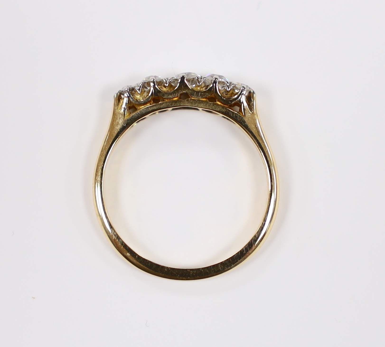 A 1920's 18ct, plat and graduated five stone diamond set half hoop ring, size K/L, gross weight 2.6 grams.